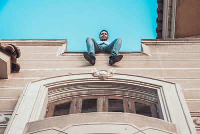 Low angle view of woman against sky