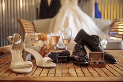 Close-up of personal accessories with drinks on table at wedding ceremony