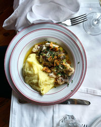 Traditional portugal food cod fish with potato purée. plate on white tablecloth