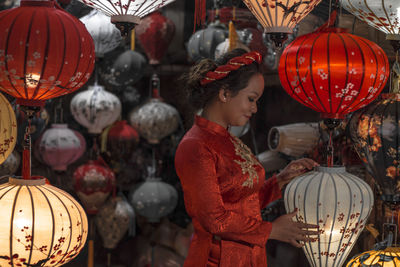 Full length of woman holding red lantern