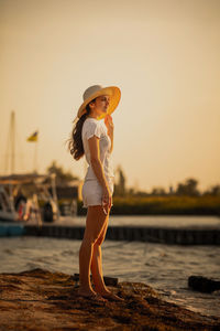 Full length of woman standing on beach