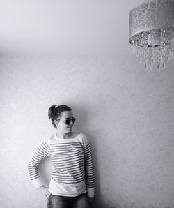 Portrait of boy standing against wall