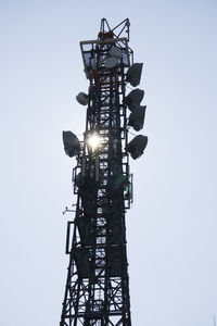 Low angle view of communications tower against sky