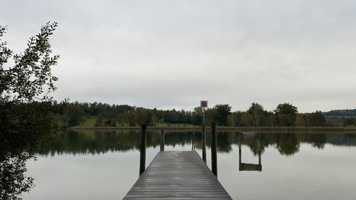Scenic view of pier over lake against sky