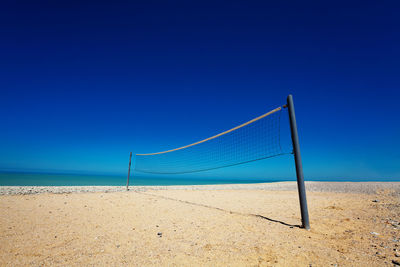 Scenic view of beach against clear blue sky