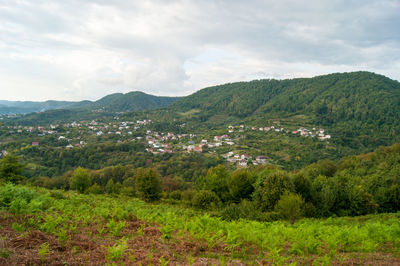 Scenic view of landscape and mountains against sky