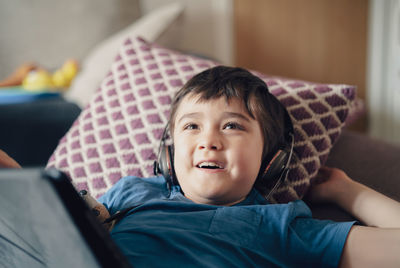 Portrait of boy on bed at home