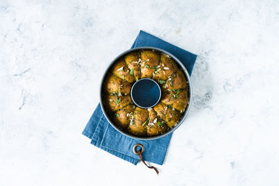 High angle view of bread in plate against white background