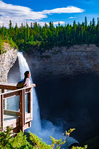 Scenic view of waterfall against sky