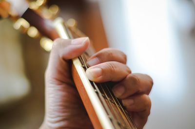 Close-up of hand playing guitar