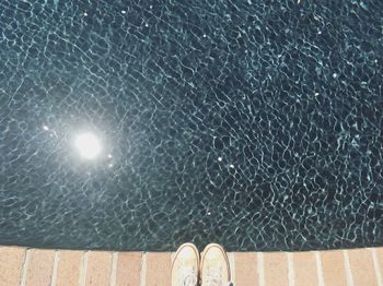 Low section of person on swimming pool