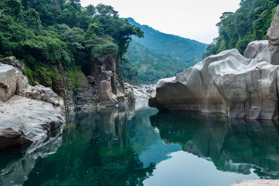 River water with naturally formed white shiny stone in unique shape at dry river bed at morning