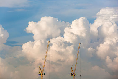 Low angle view of crane against sky