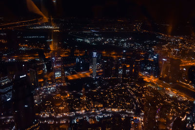 High angle view of city lit up at night