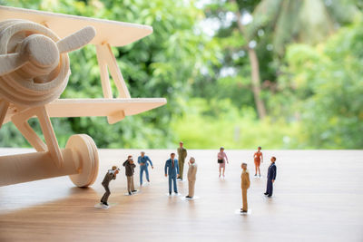 Close-up of figurines and model airplane on table representing travel