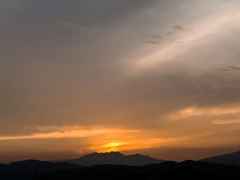 Scenic view of silhouette mountains against sky during sunset