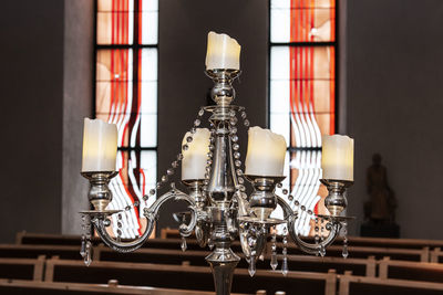 Close-up of illuminated electric lamp on table