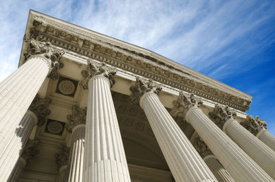 Low angle view of historical building against sky, courthouse in montpellier, france