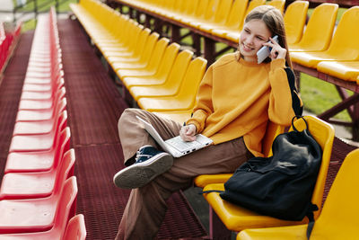 Side view of woman sitting in train