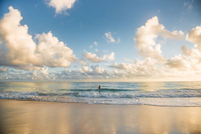 Scenic view of a lone swimmer in the ocean 