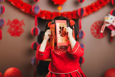 Cute girl wearing costume standing at home