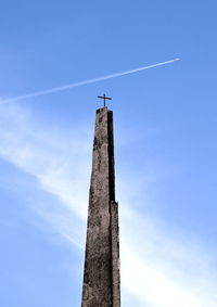 Low angle view of airplane flying against blue sky