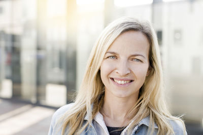 Close-up portrait of smiling young woman