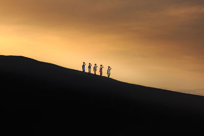 Silhouette man against sky during sunset