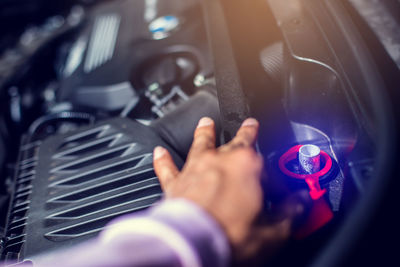 Cropped hand of man holding steering wheel