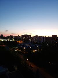 High angle view of illuminated buildings against sky at night