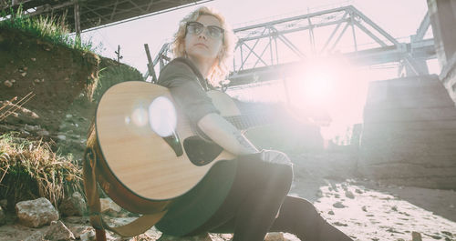 Portrait of woman sitting on sunny day