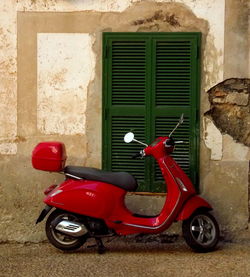 Close-up of motor scooter against wall