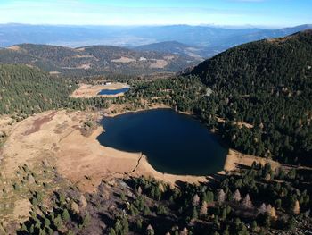 High angle view of lake and mountains against sky