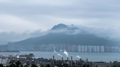 Scenic view of buildings in city against sky