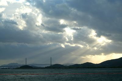 Scenic view of storm clouds over silhouette water