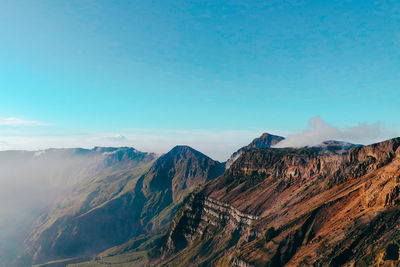 Scenic view of mountain range against blue sky