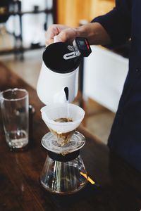 Man pouring coffee in cup