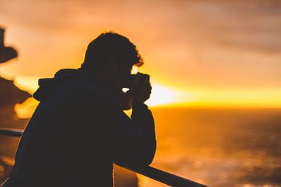 Silhouette of woman at sunset