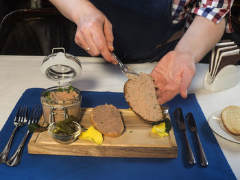 Close-up of man preparing food on cutting board