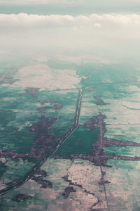 Aerial view of agricultural field against sky