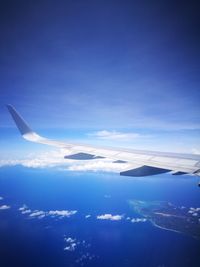 Aerial view of airplane wing against sky