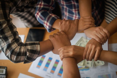 Cropped image of people forming hand chain