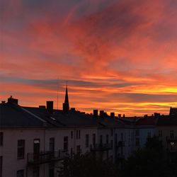 Exterior of silhouette buildings against sky during sunset