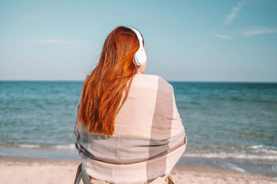 Rear view of woman looking at sea shore