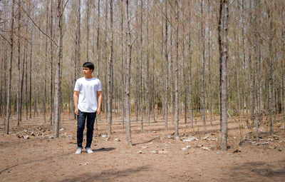 Full length of man standing in forest