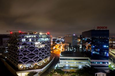 High angle view of illuminated buildings against sky at night