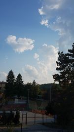 Low angle view of trees and buildings against sky