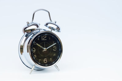 Close-up of clock over white background