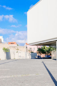 Road by building against sky