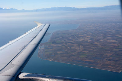 Aerial view of airplane wing over landscape